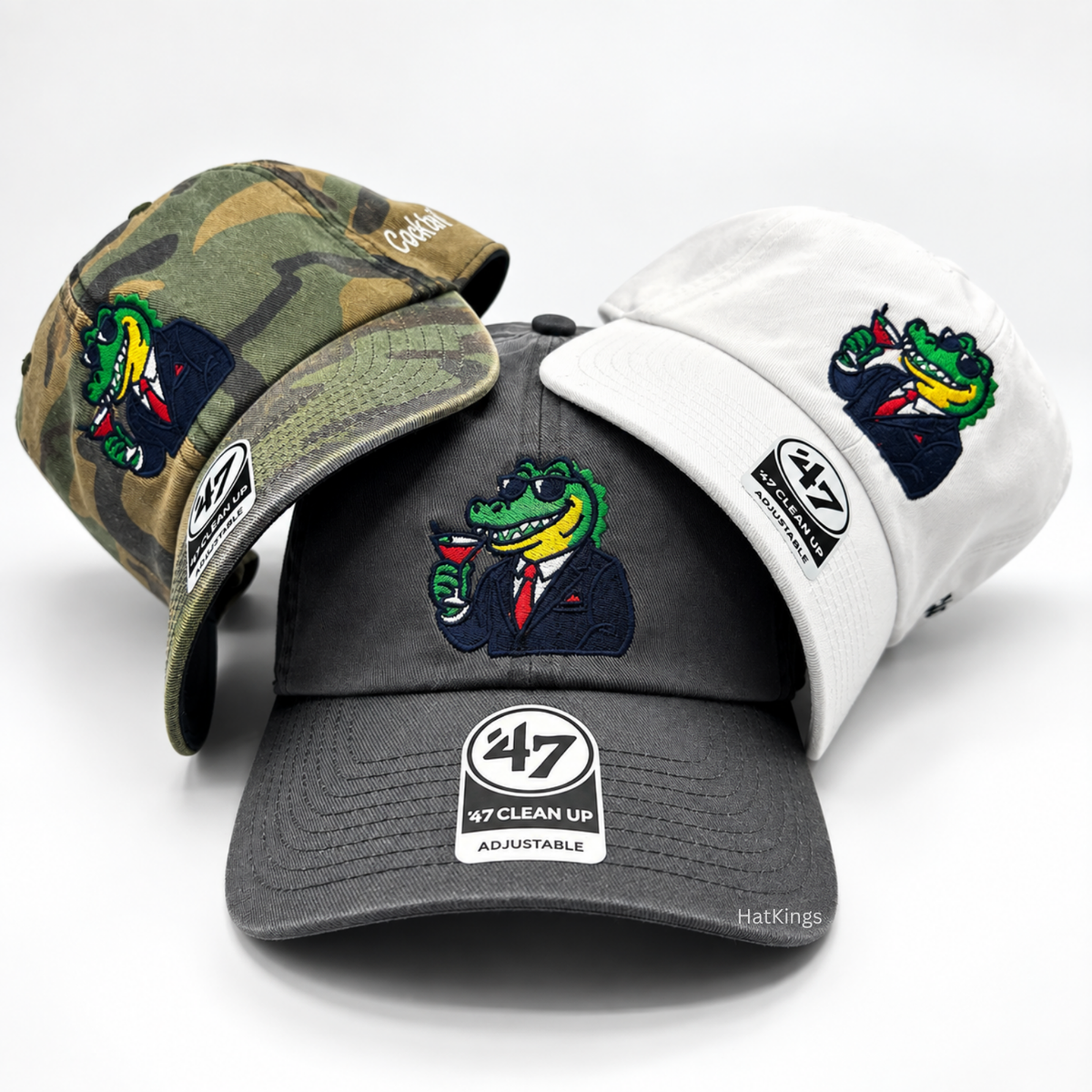 Three 47' hats in grey, white and camo with an embroidered logo.